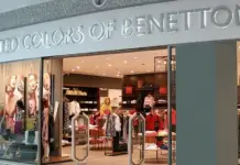CCC Urges Benetton to Pay Severance to Croatian Workers Storefront of a United Colors of Benetton shop in a mall, with mannequins and clothing displays inside the brightly lit store sign visible above.