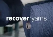 Pioneering Circular Fashion: Recover™ Launches Ready-to-Use Recycled Cotton Yarns Blue yarn spools on a textile machine with the 'recover yarns' logo across the center.