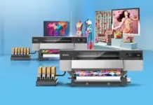 Epson Launches High-Speed SureColor F20030 Textile Printer Two Epson large-format printers in a bright blue studio printing colorful fabric‑like designs with ink tanks visible on the side.