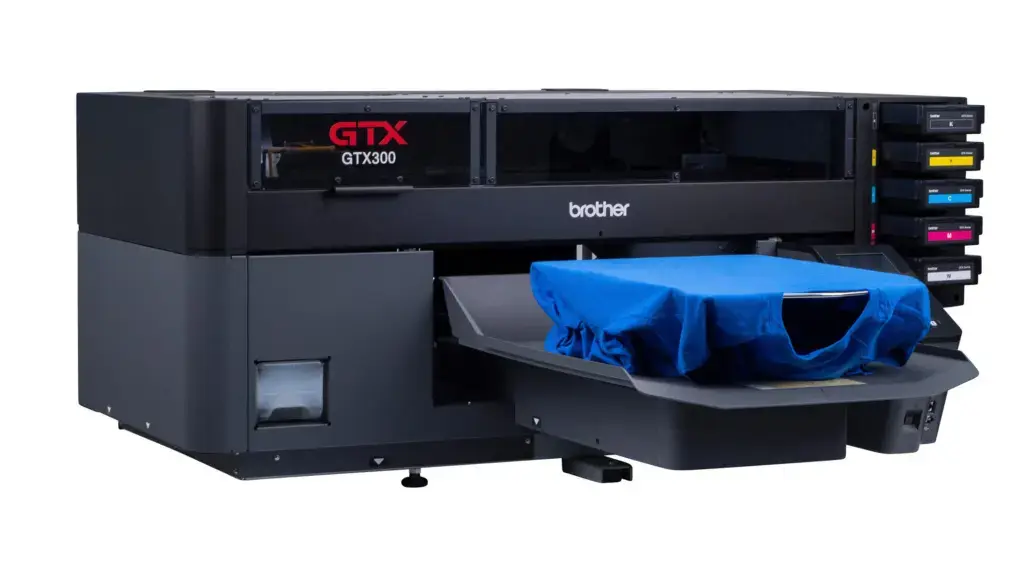 Brother GTX300 large-format printer with ink cartridge modules on the right and a blue protective cover over the output area