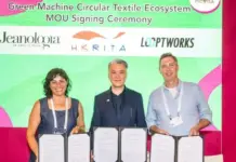 Jeanologia Partners with HKRITA and Looptworks for Circular Textile Ecosystem Three people holding signed MOUs at the Green Machine Circular Textile Ecosystem signing ceremony with a bright green backdrop beside sponsor logos