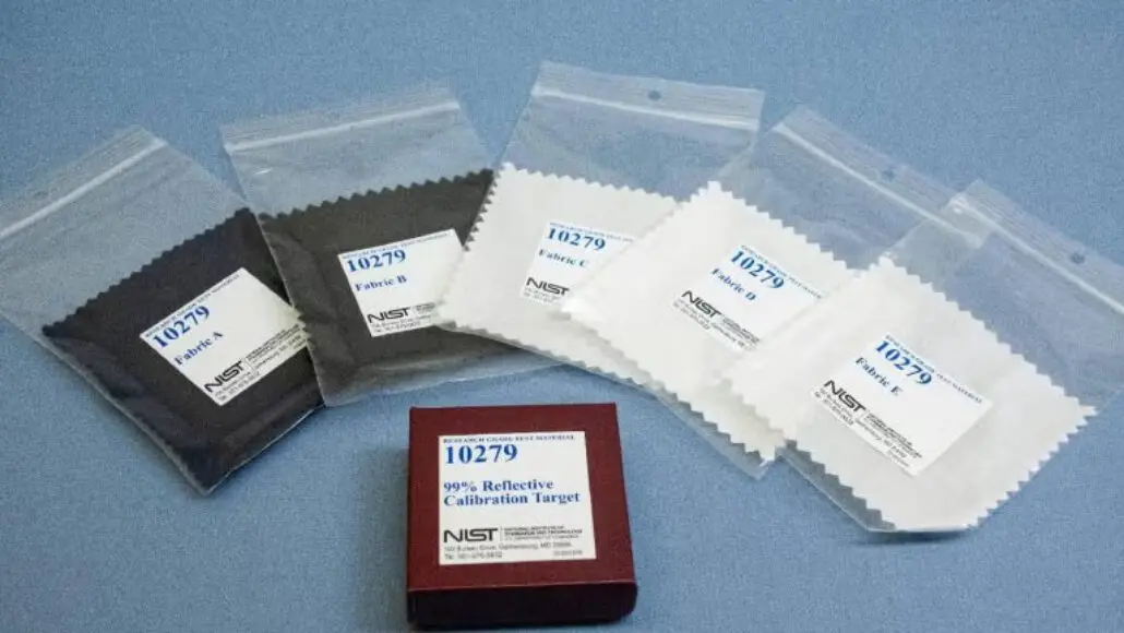Set of calibration targets in sealed bags (black and white) with a red box labeled '10279 99% Reflective Calibration Target' on a blue surface.