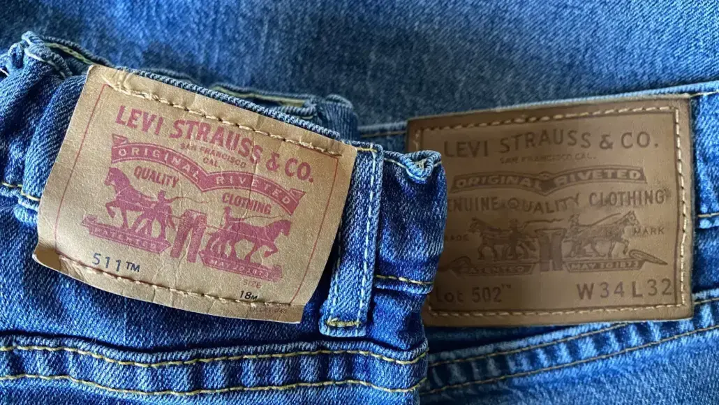Back view of blue jeans with brown Levi's leather patch showing 'Levi Strauss & Co' text and horse motif on the left pocket area.