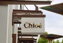 Richemont Q1 FY27 Sales Jump 20% on Strong Global Luxury Demand Exterior storefront sign reading 'Chloé' in gold letters on a white panel.