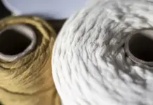 Recover and Unteks Collaborate to Scale Recycled Cotton Production Close-up of two large yarn skeins, white and brown, showing textured fibers.