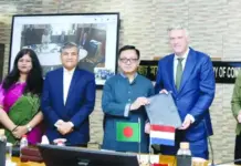 Bangladesh and Netherlands Formalize Cooperation to Advance Circular Economy in Textiles Group of officials at a signing ceremony; Bangladesh and Netherlands flags visible as two men exchange documents.