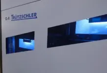 Truetzschler CL-X Enhances Global Cotton Fiber Recovery and Efficiency Industrial textile machine with the Trützschler CL-X logo visible and blue-lit viewing windows on the side panel