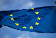EU Imposes Definitive Anti-Dumping Duties on Polyamide Yarn Imports from China European Union flag waving on a flagpole with a circle of 12 yellow stars on blue field.