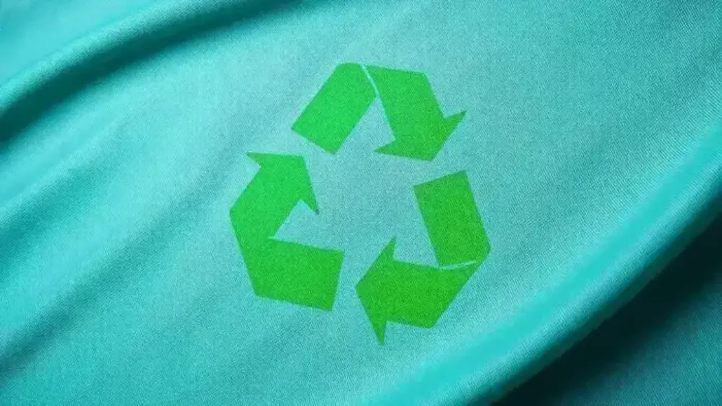Teal fabric with a bright green recycling symbol.