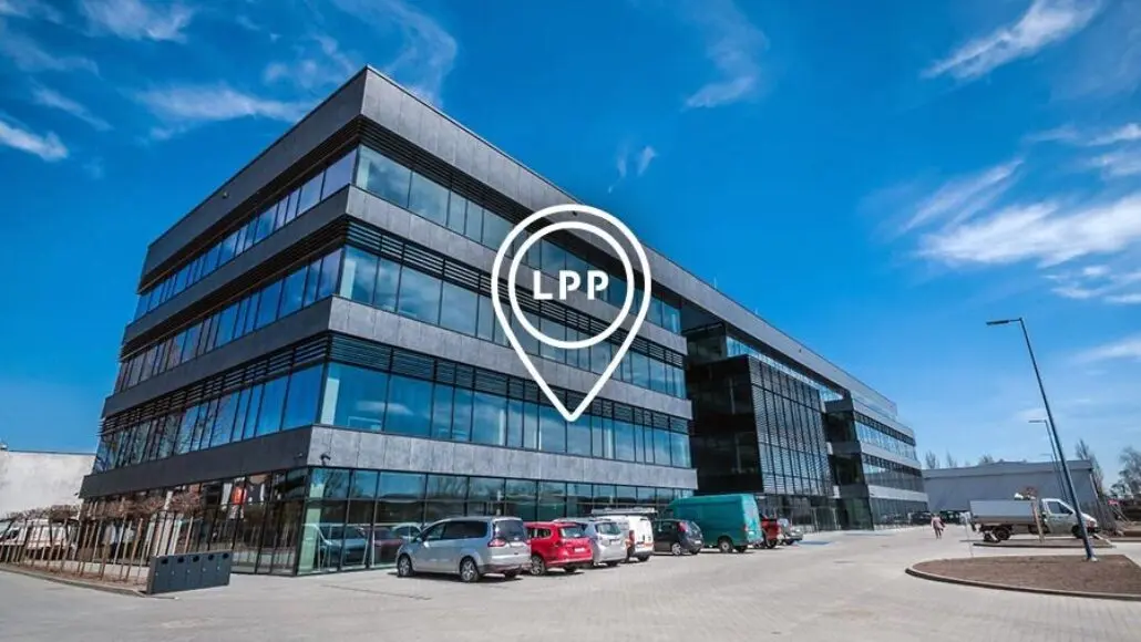 Modern glass office building under a blue sky with a white location pin overlay labeled LPP.