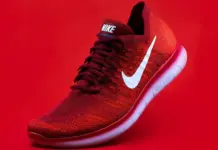 Zotefoams Faces Backlash Over Plans to Cut 100 Croydon Jobs and Move Manufacturing to Vietnam Red Nike running shoe with white swoosh on a red background, angled to show the side and sole edge.