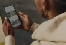 Vinted Expands Global Footprint with Official Australia Launch Person holding a smartphone and browsing a gallery of images on the screen.