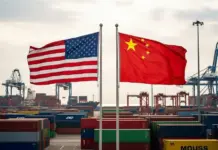Washington and Beijing Eye Reciprocal Tariff Cuts – But Clothing Remains Left Out American and Chinese flags wave over a busy shipping port with stacked cargo containers and cranes in the background, signaling international trade.
