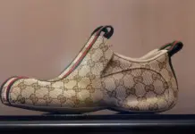 Gucci’s ‘The Drip’ Sneaker Made in China Redefines Luxury Manufacturing Standards Beige Gucci monogram slip-on loafer with red‑green stripe and heel tabs on each side.