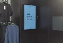Tesco Trials Virtual Try-On Technology for F&F Clothing Range at Sandhurst Store Digital sign in a clothing store reads 'Use virtual try-on' beside clothing racks.