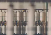 Bangladesh Tightens Yarn Import Rules to Unlock $1.5 Billion in Local Textile Investment Rows of white yarn spools on a weaving loom in a textile factory setting.