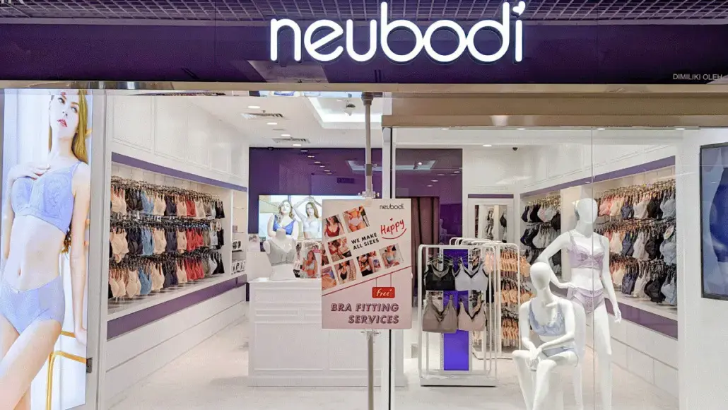 Neubodi lingerie store interior with mannequins in bras, rows of underwear on shelves, and a sign advertising bra fitting services.