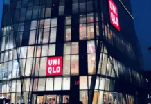 Uniqlo Eyes H&M’s No. 2 Spot After Record Sales and Profits on Global Boom Nighttime view of a glass-front UNIQLO store with illuminated red UNIQLO logos on the facade.